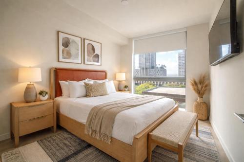 a bedroom with a large bed and a large window at Crosby Miami World Center in Miami