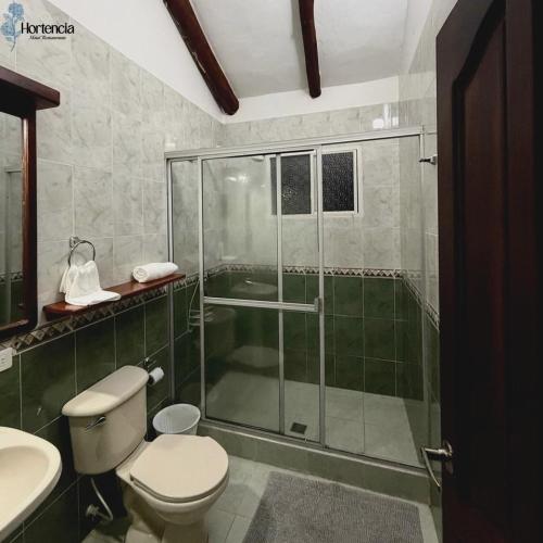 a bathroom with a shower and a toilet and a sink at Hotel restaurante hortencia in La Mesa