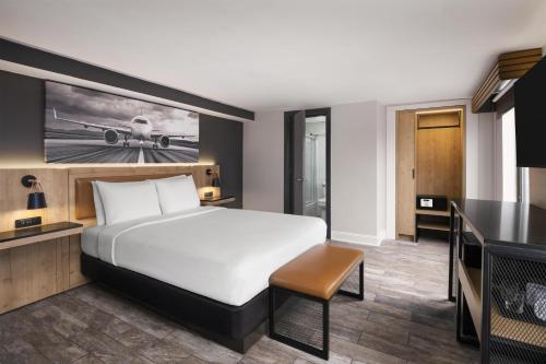 a hotel room with a bed and a television at Aiden by Best Western Newark Airport in Newark