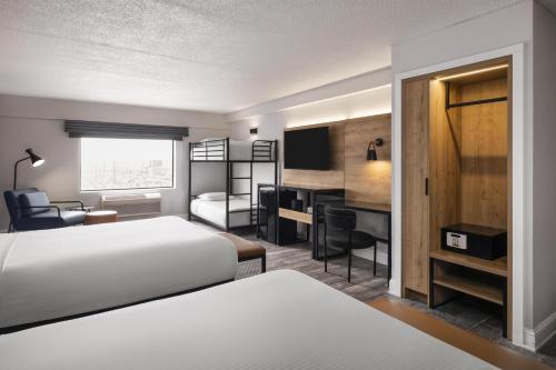 a hotel room with two beds and a desk at Aiden by Best Western Newark Airport in Newark