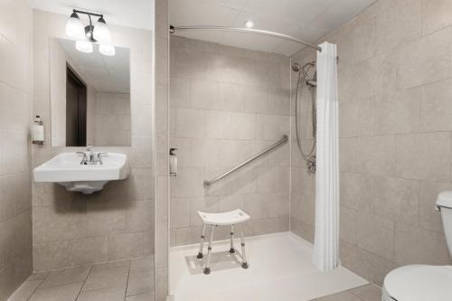 a bathroom with a shower and a sink and a toilet at Aiden by Best Western Newark Airport in Newark