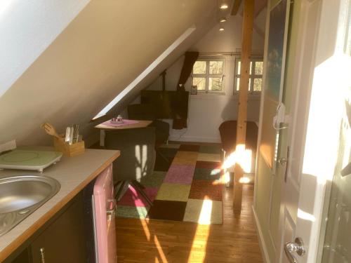 a bathroom with a sink and a staircase with a stair at gemütliches Gästezimmer in Ostseenähe in Stubbendorf