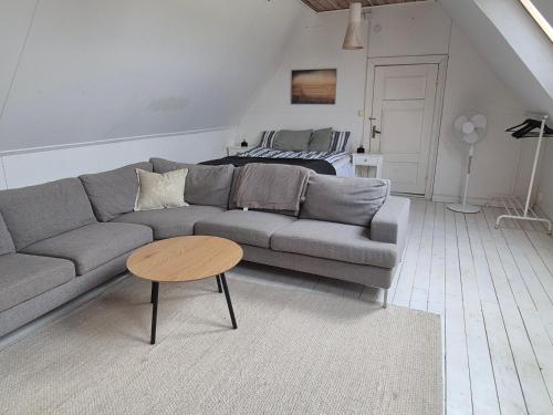 a living room with a couch and a table at Solbacken in Bjärred