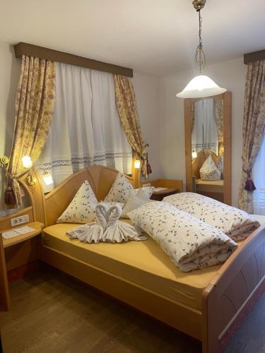 a bedroom with a bed with pillows on it at Haus Käfersberg in Naturno
