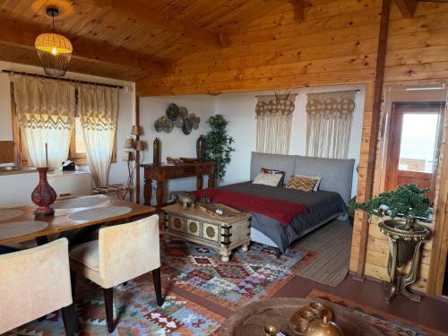 a bedroom with a bed and a table in a room at São Jorge Spot - Alojamento in Velas