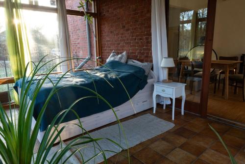 a bedroom with a bed and a table and a window at Zur Waldschmiede in Kakenstorf