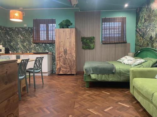 a bedroom with two beds and a kitchen and a table at Casa Sole in Rivoli