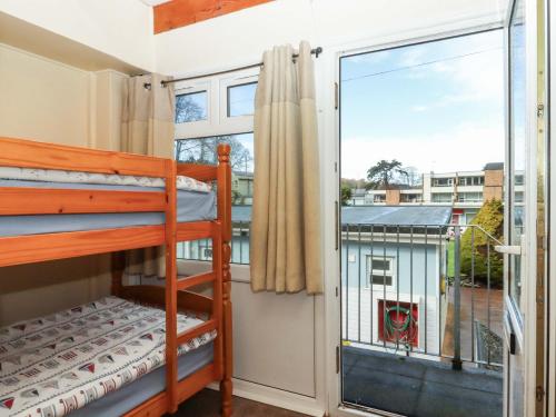 a bedroom with bunk beds and a large window at Sea Glimpse in Dawlish
