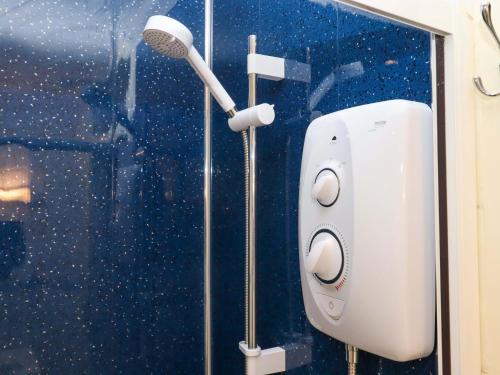 a shower with a hair dryer in a bathroom at Sea Glimpse in Dawlish