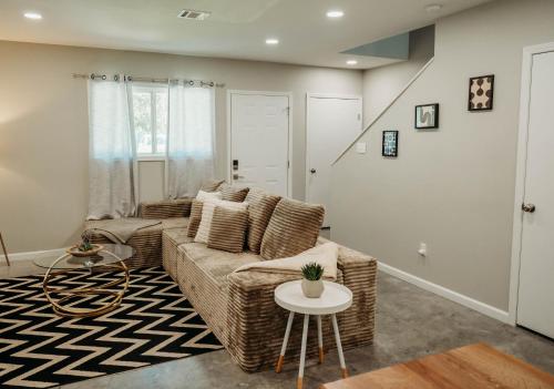 a living room with a couch and a table at Freetown Blueplex Downtown Lafayette in Lafayette