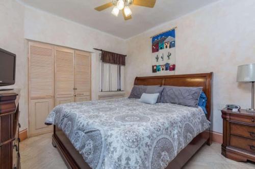 a bedroom with a bed and a dresser and a tv at Unique Colorful Condo on 3rd Floor Pinacate 321 in Puerto Peñasco