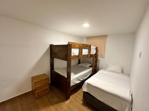 a room with two bunk beds and a bed at Modern house with pool in Ica in Ica