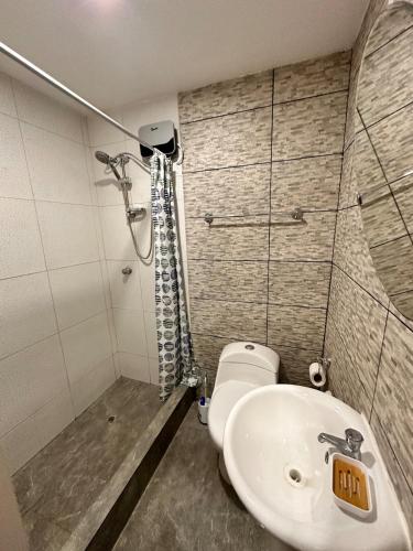 a bathroom with a toilet and a sink and a shower at Modern house with pool in Ica in Ica