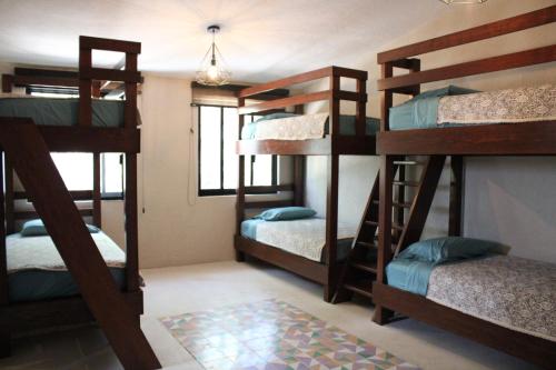 a bunk bed room with four bunk beds in it at Casa Ancestra in Santa Cruz