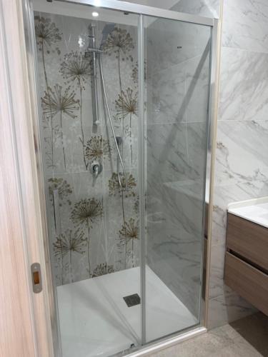 a shower with a glass door in a bathroom at Sofia s Rooms in Falcone