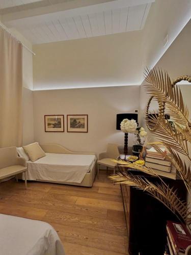 a bedroom with a bed and a couch and a table at Camilla Garden in Pisa