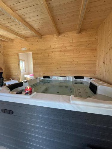 a jacuzzi tub in a room with wooden walls at Villa Concordia in Villaggio Mosè