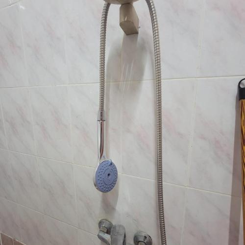 a shower with a strainer in a bathroom at A ROOM in mandara in Alexandria