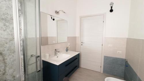 a bathroom with a sink and a mirror at Villa 21 in Budoni