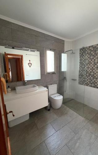 a bathroom with a toilet and a sink and a shower at Villa Sunset Tauro in Mogán