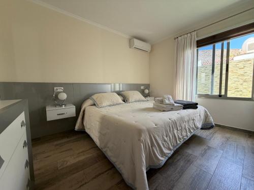 a bedroom with a bed and a large window at Villa Sunset Tauro in Mogán