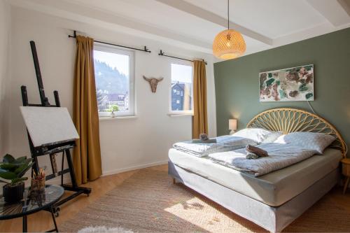 a bedroom with a bed and a painting on the wall at Bergsonnen-Stuben in Bad Lauterberg