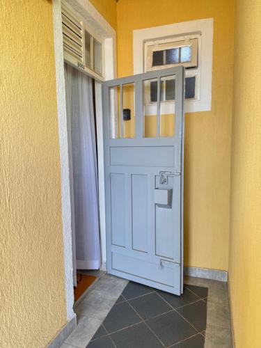 a white door in the corner of a room at Bella apartment studios town in Meru