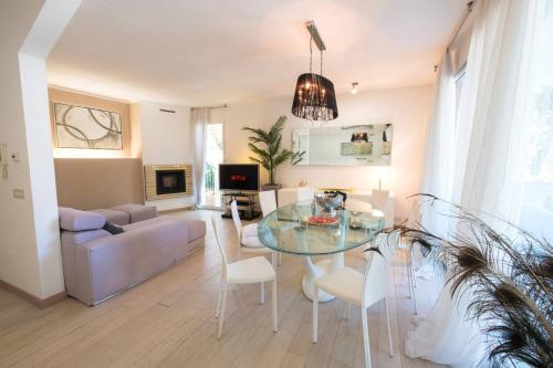 a living room with a glass table and chairs at Villa Irene in Cervia