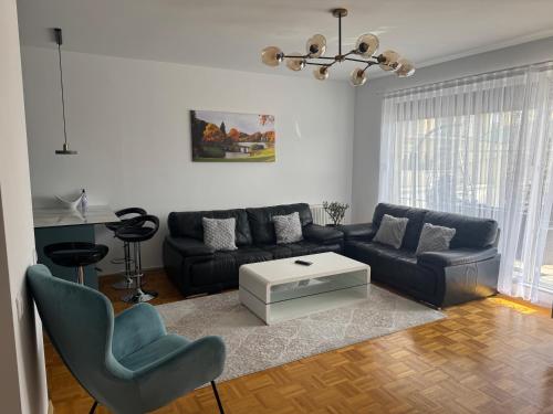 a living room with a couch and a table at Sonny Penthouse 2 in Gnjilane