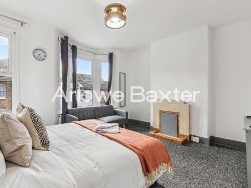 a bedroom with a bed and a fireplace at East LDN Guest Rooms and Amenities in London