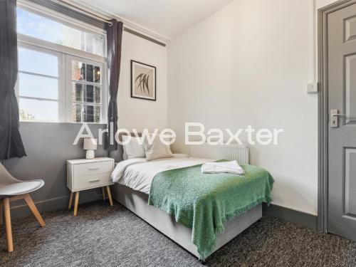 a bedroom with a bed and a window at East LDN Guest Rooms and Amenities in London