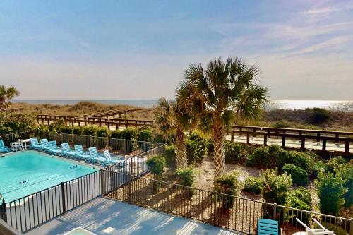 a view of a swimming pool and the beach at La Mare Vita in Carolina Beach