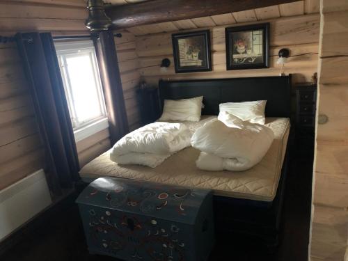 a bedroom with a bed with pillows and a window at Kvitfjell in Ringebu