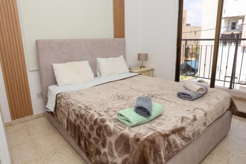 a bedroom with a bed with towels on it at Spacious 2 BR appartment near mall -Internet 1Gbps in Paphos