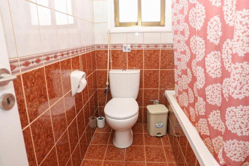 a bathroom with a toilet and a window and a shower at Spacious 2 BR appartment near mall -Internet 1Gbps in Paphos