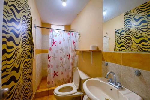 a bathroom with a sink and a toilet and a shower at Smart San Miguel in Lima