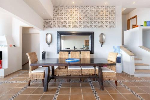 a dining room with a table and chairs and a mirror at Beautiful Huge Beachfront Home Serenity Beach in Puerto Peñasco