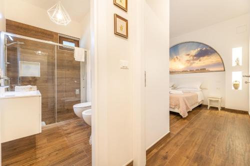 a bathroom with a shower and a toilet and a sink at Villa Icaria in Carovigno