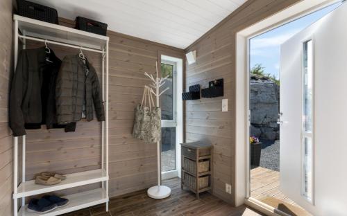 a walk in closet with a wooden wall at Modern cabin with panoramic views in Porsgrunn