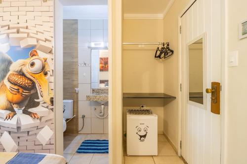 a bathroom with a dinosaur mural on the wall at Delphin Beach Hotel - Suíte 238 in Guarujá
