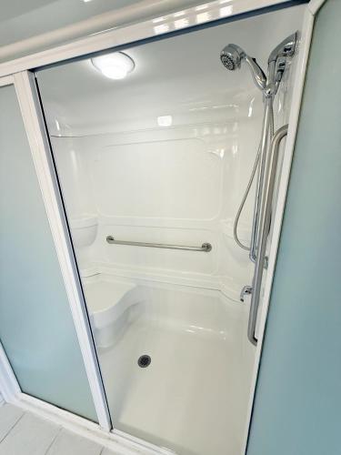 a shower in a bathroom with a glass door at Travelodge by Wyndham Drumheller AB in Drumheller