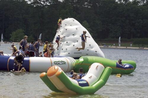 a group of people in the water on inflatables in a lake at Callaway Resort & Gardens in Pine Mountain