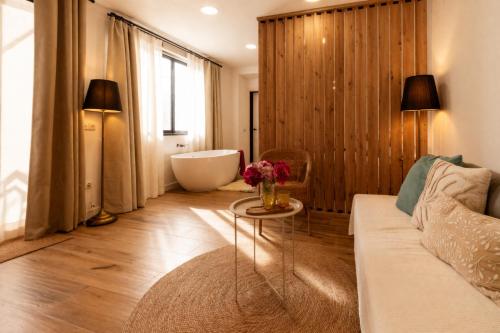 a living room with a couch and a bath tub at Private Loft Sant Celoni, Montseny, Barcelona in Sant Celoni