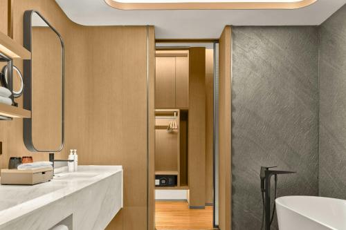 a bathroom with two sinks and a mirror at AC Hotel by Marriott Hangzhou in Hangzhou