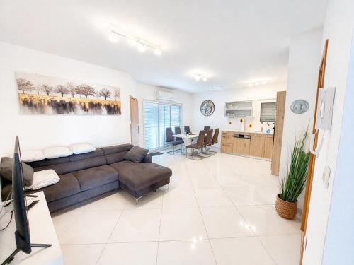 a living room with a couch and a table at Spacious 3 Bedroom Apartment 50m from Sea 2 Bathrooms 2 Terraces Near Beach in Privlaka