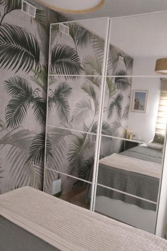 a bedroom with a mirrored wall with a bed in it at Oasis Las Eras, Tenerife in Las Eras