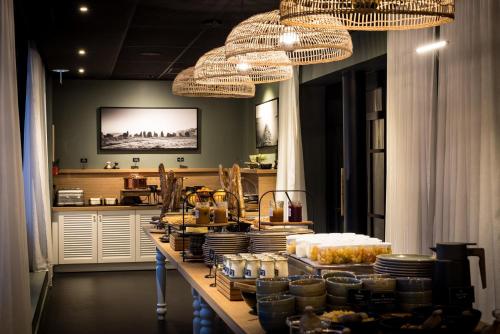 a long table with food on it with chandeliers at Le Celtique & Spa in Carnac