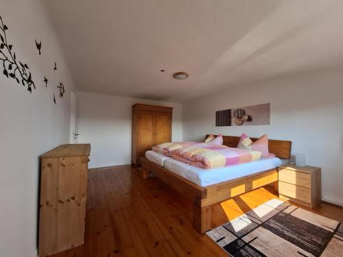 a bedroom with a bed and a wooden floor at Ferienwohung Else Sankt Wendel in Sankt Wendel