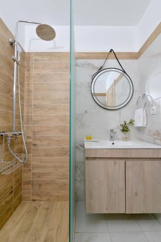 a bathroom with a sink and a shower at Pharos Rooms in Ilia