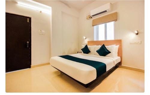 a bedroom with a large bed in a room at Hotel Silverkey luxury Rooms in Hyderabad